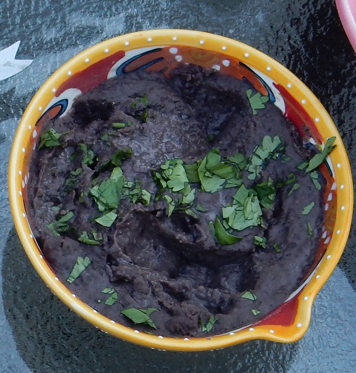 Black bean dip, garnished with cilantro.